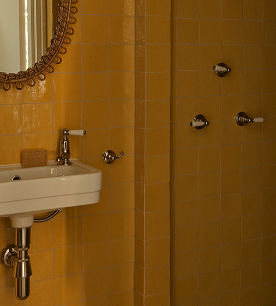 Best wall mounted bathroom basin taps and traditional rainhead shower fittings in comtemporary bathroom setting.