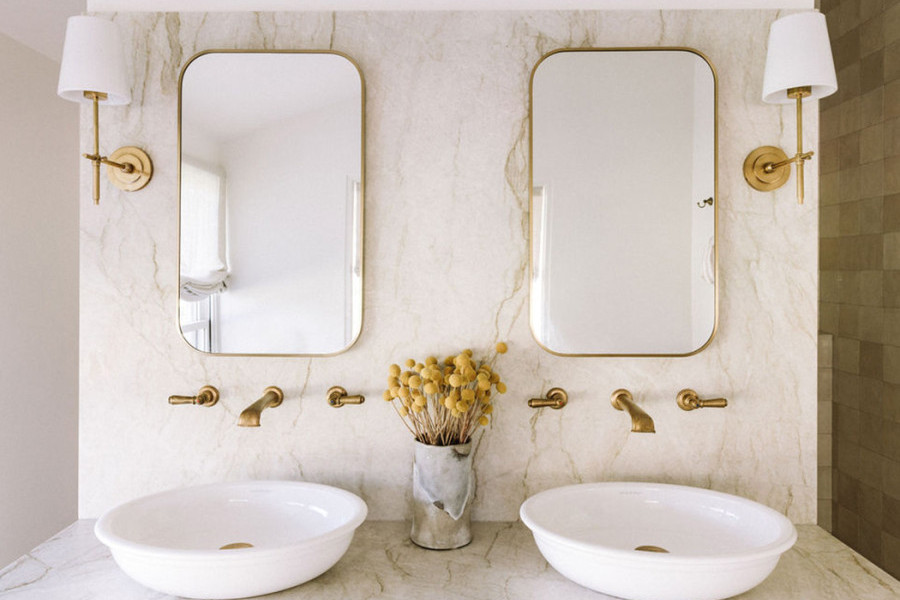 In the bathroom, polished brass Perrin & Rowe tapware and matching accessories bring cohesion and elegance, paired with Victoria & Albert freestanding baths and basins for a refined, luxurious feel. 