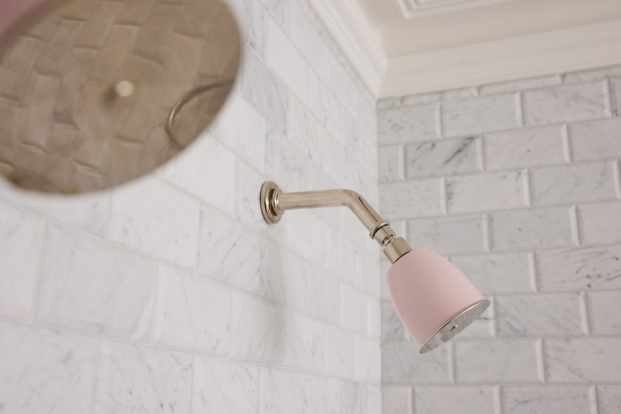 Novara master bathroom featuring polished nickel and pale pink Rockwell tapware, pink marble stone surfaces, and grey subway tiles, creating a sophisticated and romantic design.