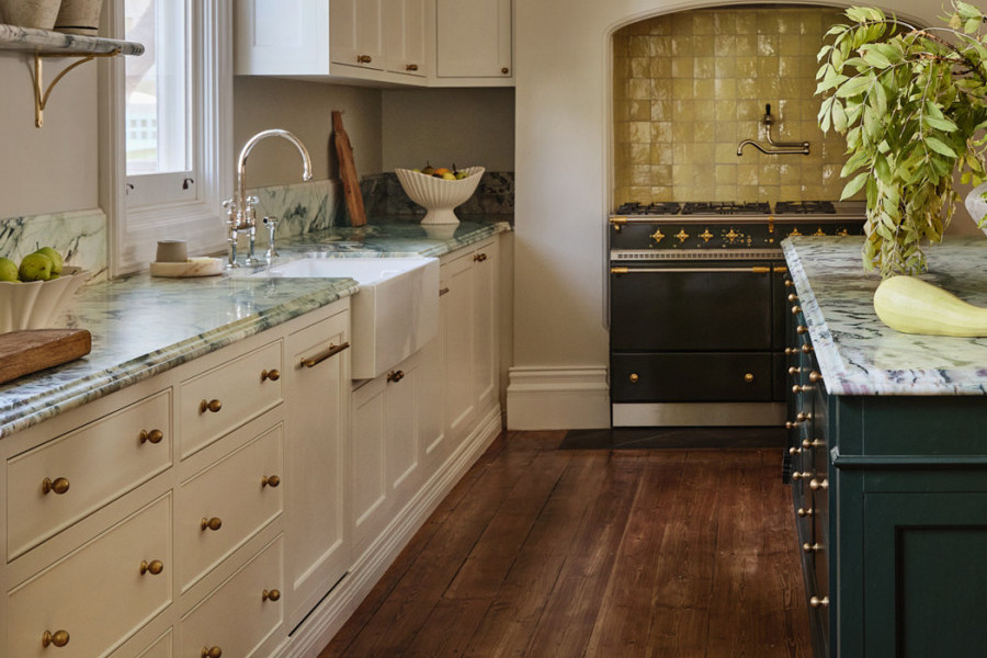 Heritage-style kitchen in Warrnambool with marble benchtops, Perrin & Rowe tapware, handcrafted joinery, and citrus-accented walls and tiles.
