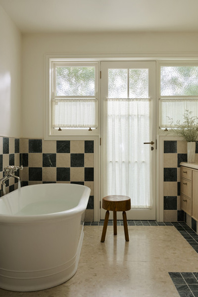 Green and taupe checkerboard tiled bathroom with Joseph Giles door hardware and Perrin & Rowe heritage tapware. 