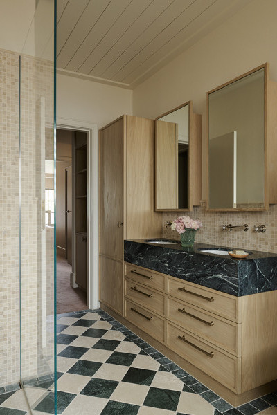 A bathroom with green and white checkerboard tiles and vanity featuring Perrin & Rowe traditional nickel tapware and aged brass drawer hardware from Armac Martin. 