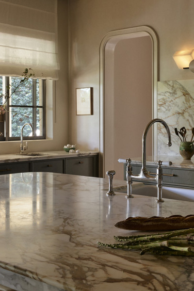 A kitchen with marble bench and Perrin & Rowe nickel tapware from In Residence.