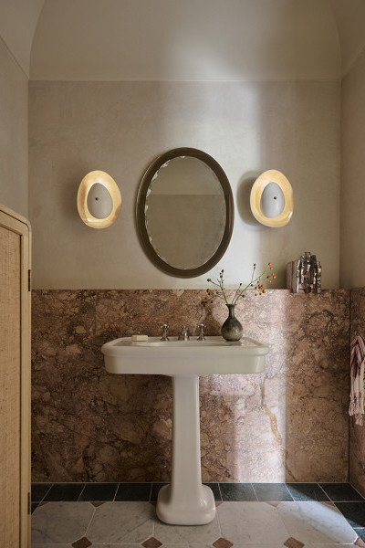 A WC with pink marble with white classic basin from The Water Monopoly and Polished Nickel traditional  
Perrin & Rowe hot and cold taps and mixer.