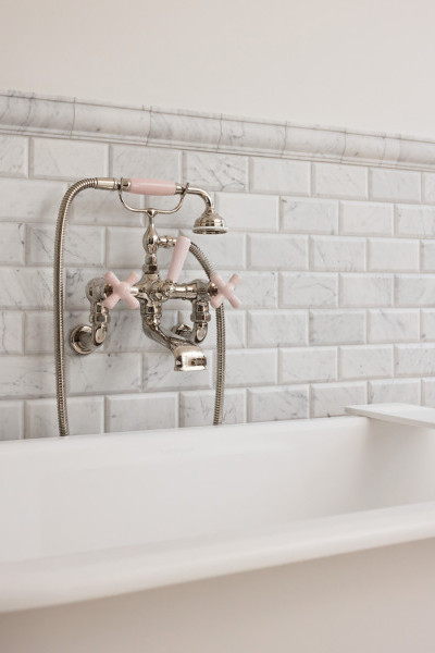 Novara master bathroom featuring polished nickel and pale pink Rockwell tapware, pink marble stone surfaces, and grey subway tiles, creating a sophisticated and romantic design.