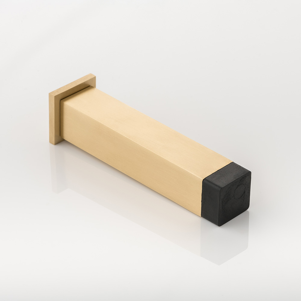 Cube II solid brass wall-mounted door stopper with decorative stepped plate